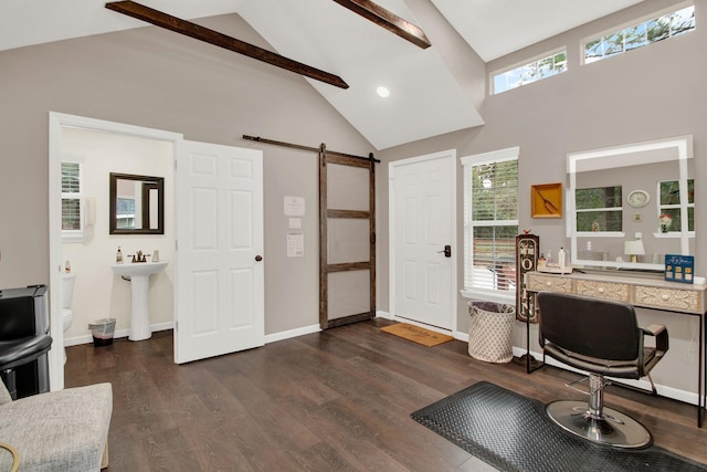 office area with vaulted ceiling with beams, a barn door, sink, and dark wood-type flooring