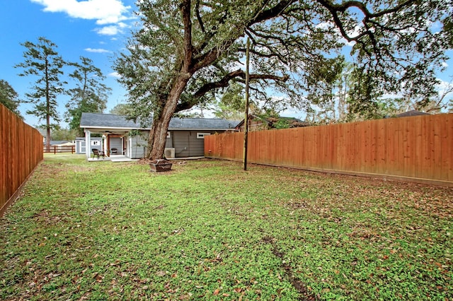 view of yard featuring a patio and a fire pit