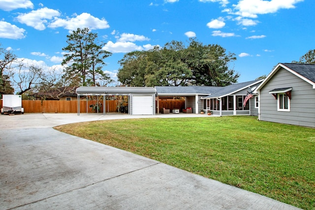 view of front facade with a sunroom, a carport, a garage, and a front lawn