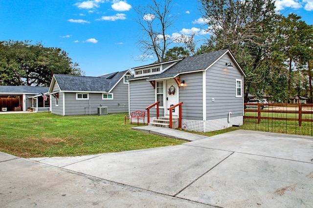 view of front of house featuring cooling unit and a front lawn