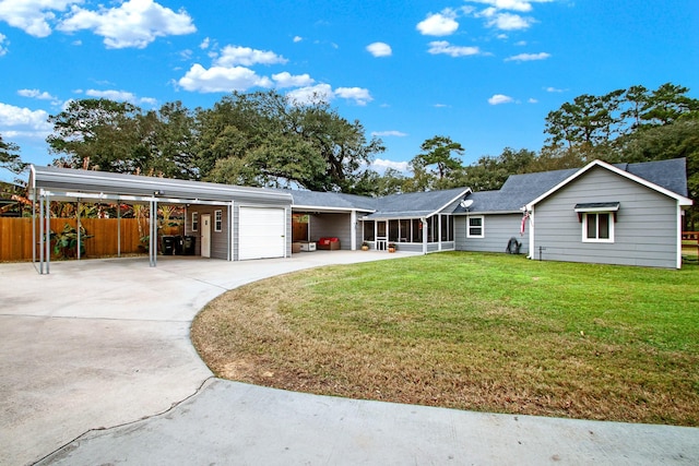 ranch-style home with a sunroom, a front yard, and a carport