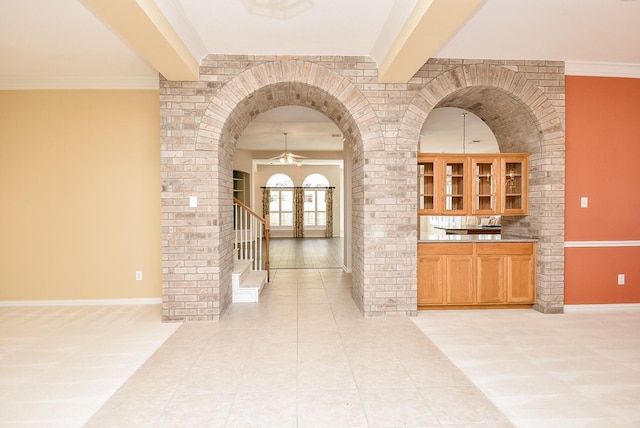 hallway featuring crown molding and light tile patterned flooring