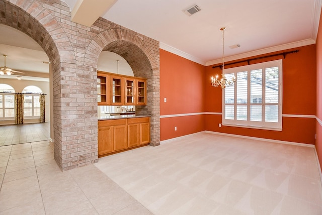 kitchen featuring light tile patterned floors, pendant lighting, ceiling fan with notable chandelier, and ornamental molding