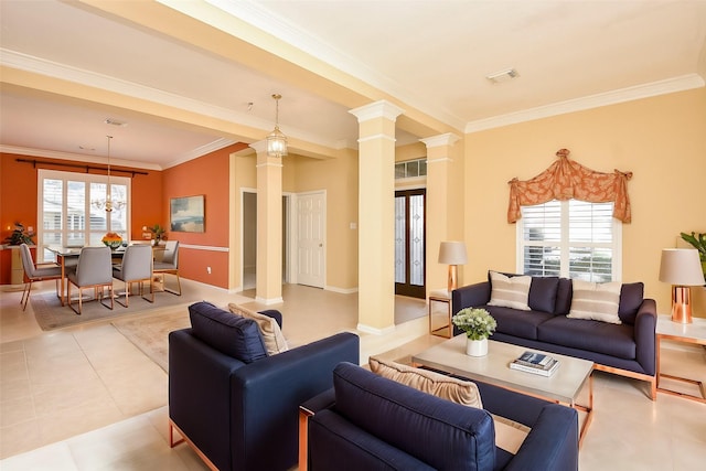 living room featuring a chandelier, decorative columns, a wealth of natural light, and crown molding