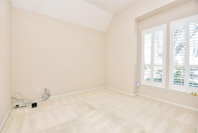 unfurnished room with carpet and lofted ceiling