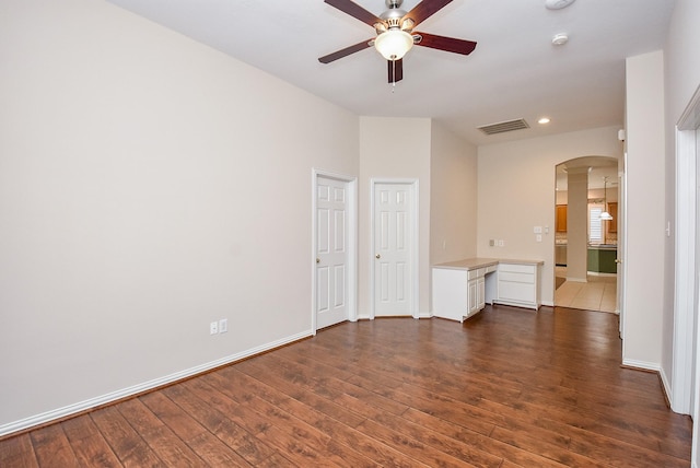 unfurnished room with ceiling fan and dark hardwood / wood-style floors