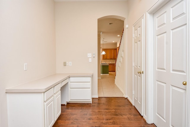 hallway with dark hardwood / wood-style flooring