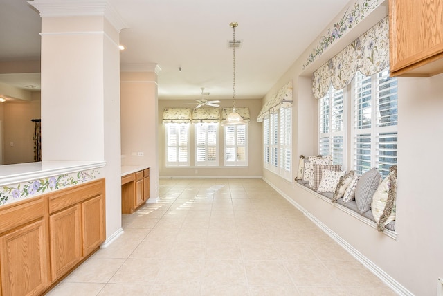 interior space with ceiling fan, plenty of natural light, light tile patterned flooring, and decorative light fixtures