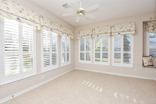 unfurnished sunroom with ceiling fan