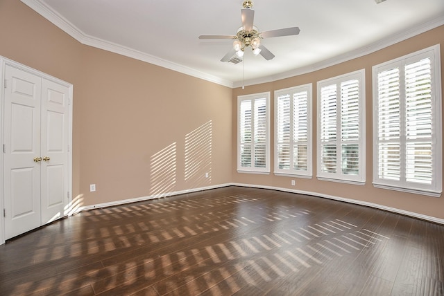 empty room with dark hardwood / wood-style flooring, ceiling fan, and ornamental molding