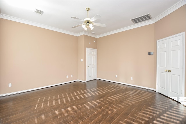 spare room with ceiling fan, dark hardwood / wood-style flooring, and crown molding