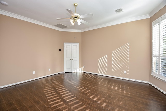 spare room featuring dark hardwood / wood-style flooring, ceiling fan, and ornamental molding