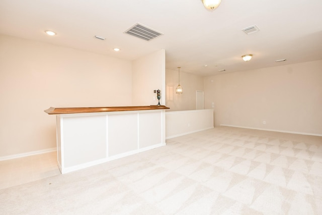 unfurnished room with light colored carpet