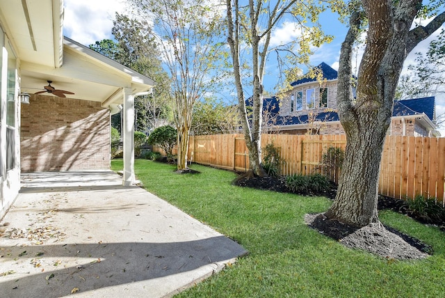 view of yard featuring a patio area and ceiling fan