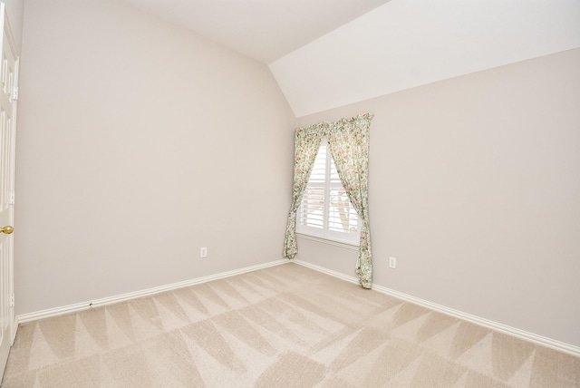 unfurnished room with carpet and vaulted ceiling