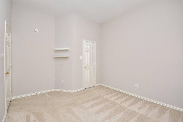 unfurnished room featuring light colored carpet