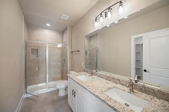 bathroom with tile patterned floors, toilet, an enclosed shower, and vanity