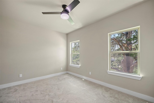 unfurnished room featuring light carpet and ceiling fan