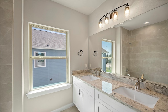 bathroom featuring vanity and tiled shower / bath