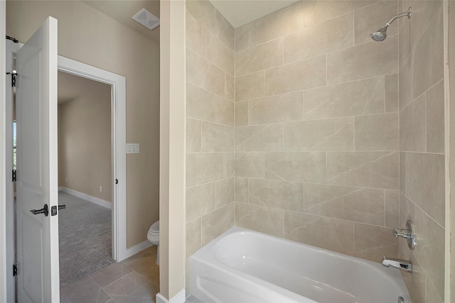 bathroom with shower / bathing tub combination, toilet, and tile patterned floors