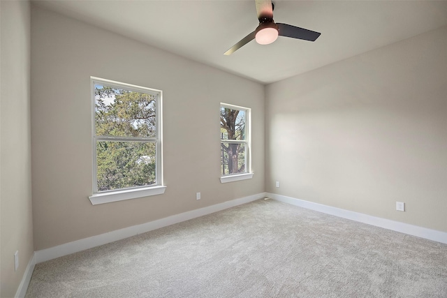 carpeted empty room featuring ceiling fan