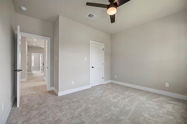 unfurnished bedroom featuring ceiling fan and light carpet