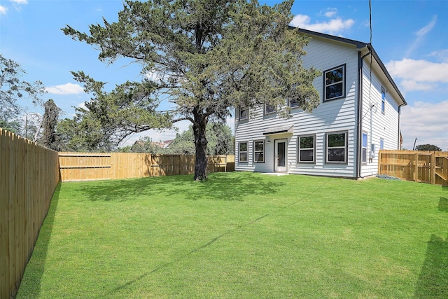 back of property featuring a lawn