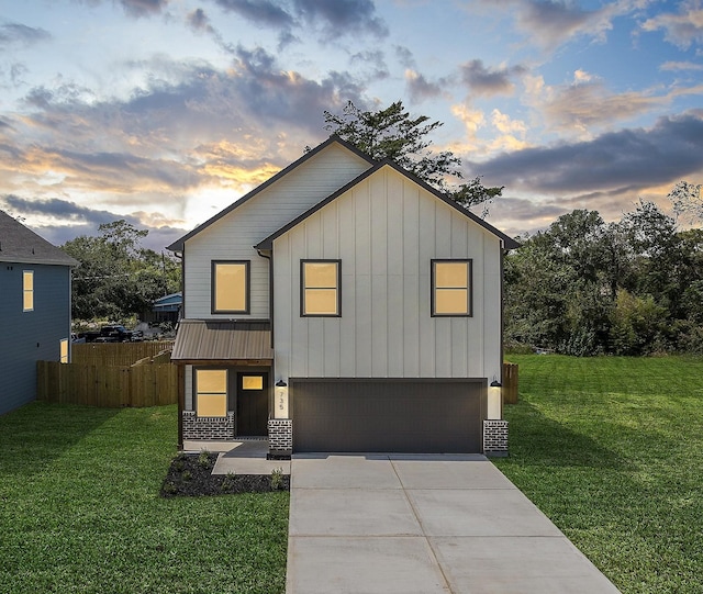 view of front facade with a lawn and a garage