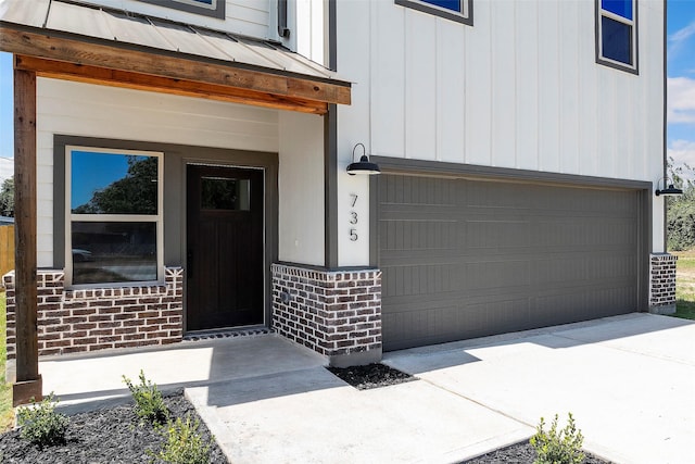 view of exterior entry featuring a garage