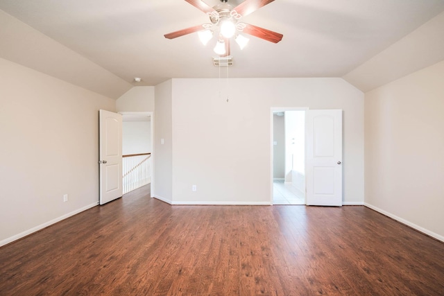 interior space with lofted ceiling, ceiling fan, and dark wood-type flooring