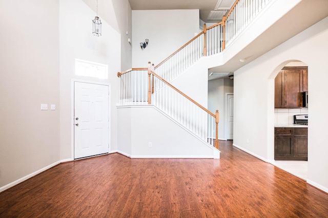 foyer featuring a high ceiling and wood-type flooring