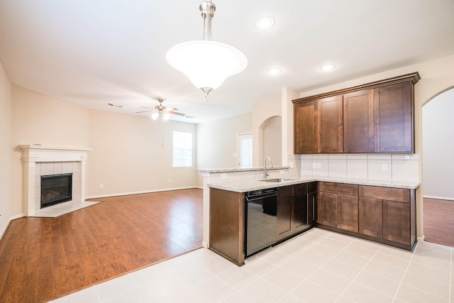 kitchen featuring ceiling fan, dishwasher, sink, pendant lighting, and light tile patterned flooring