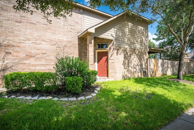 doorway to property featuring a yard