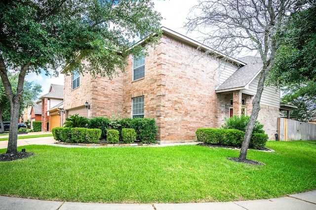 view of front facade with a garage and a front lawn