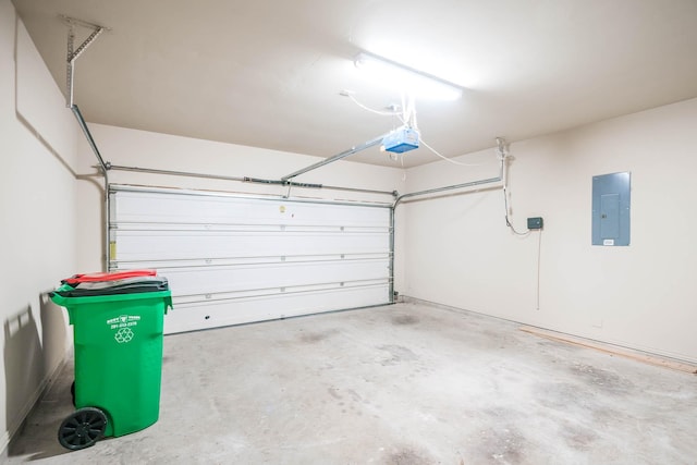 garage featuring electric panel and a garage door opener