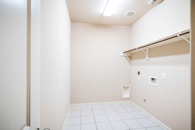 laundry area with gas dryer hookup, hookup for a washing machine, light tile patterned floors, and hookup for an electric dryer