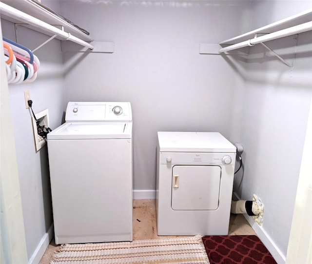 clothes washing area featuring independent washer and dryer