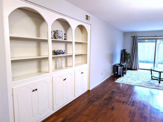 interior space with built in features and dark wood-type flooring