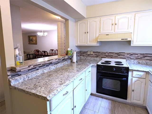 kitchen with kitchen peninsula, tasteful backsplash, black electric range, a chandelier, and white cabinetry