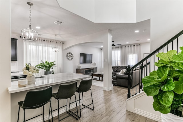 kitchen with a kitchen bar, plenty of natural light, and pendant lighting