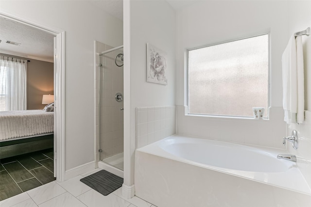 bathroom with ornamental molding, a textured ceiling, and independent shower and bath