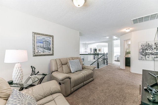 carpeted living room with a textured ceiling