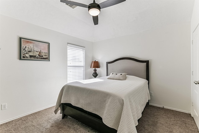 bedroom with ceiling fan and dark colored carpet