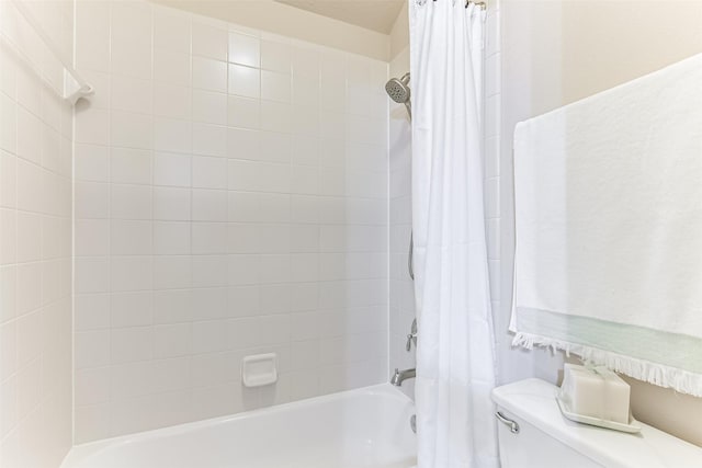 bathroom with shower / bath combo with shower curtain and toilet