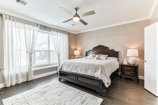 bedroom featuring a textured ceiling, ceiling fan, and ornamental molding