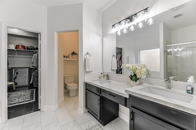 bathroom with walk in shower, tile patterned flooring, vanity, and toilet