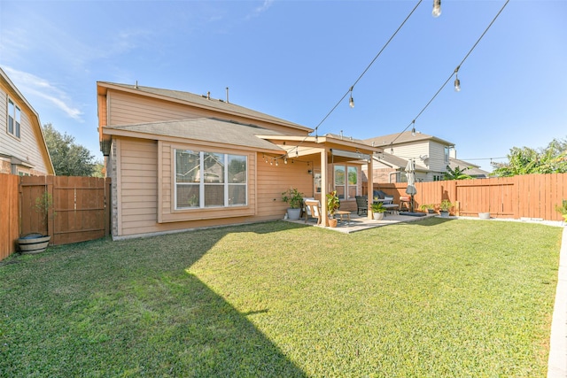 rear view of house featuring a lawn and a patio area