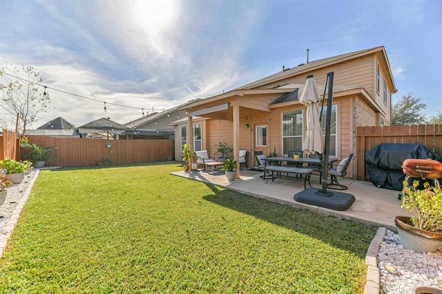 rear view of house with a patio and a lawn