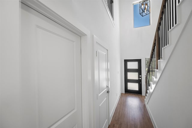745 20th St, Hempstead, TX 77445 - doorway to outside with dark hardwood / wood-style flooring, a towering ceiling, and an inviting chandelier