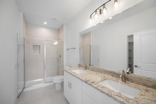 745 20th St, Hempstead, TX 77445 - bathroom with tile patterned flooring, vanity, toilet, and a shower with shower door